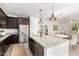 Spacious kitchen with stainless steel appliances, granite countertops, and a breakfast bar at 3910 E Turley St, Gilbert, AZ 85295