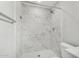 This bathroom features marble tile, a shower head, and toilet at 3933 W Nancy Ln, Phoenix, AZ 85041