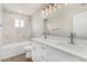 Modern bathroom features dual sinks, marble tiling and updated fixtures at 3933 W Nancy Ln, Phoenix, AZ 85041