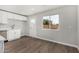 Bright kitchen boasts a window, white cabinets, modern hardware, and vinyl flooring at 3933 W Nancy Ln, Phoenix, AZ 85041