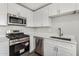 This modern kitchen features stainless steel appliances and white cabinets at 3933 W Nancy Ln, Phoenix, AZ 85041
