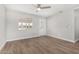 Bright living room featuring new hardwood floors and fresh paint at 3933 W Nancy Ln, Phoenix, AZ 85041