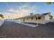 Backyard area with gravel, covered patio and white brick, perfect for outdoor activities at 4031 W Palmaire Dr, Phoenix, AZ 85051