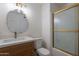 Bathroom featuring a vanity, toilet, and shower with glass doors and updated fixtures at 4031 W Palmaire Dr, Phoenix, AZ 85051