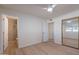 Bedroom with a ceiling fan, light wood-look floors, and ensuite bathroom and closet at 4031 W Palmaire Dr, Phoenix, AZ 85051