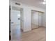 Bedroom view showing new flooring and an open closet with sliding mirrored doors at 4031 W Palmaire Dr, Phoenix, AZ 85051
