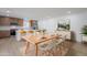 Open dining area with modern table setting, adjacent to a kitchen with stainless steel appliances and breakfast bar at 4031 W Palmaire Dr, Phoenix, AZ 85051