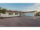 Charming single-story home with a two-car garage, desert landscaping and blue skies at 4031 W Palmaire Dr, Phoenix, AZ 85051