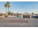 Charming single-story home with a two-car garage, desert landscaping and blue skies at 4031 W Palmaire Dr, Phoenix, AZ 85051