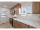 Updated kitchen with oak cabinets and white quartz countertops at 4031 W Palmaire Dr, Phoenix, AZ 85051