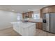 Bright open kitchen featuring island with quartz countertop and stainless steel appliances at 4031 W Palmaire Dr, Phoenix, AZ 85051