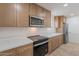 Updated kitchen with new cabinets, countertops, and stainless steel microwave and oven at 4031 W Palmaire Dr, Phoenix, AZ 85051