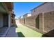A backyard features artificial turf, a concrete patio and privacy walls at 4242 E Erie St, Gilbert, AZ 85295