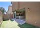 View of the kitchen through the sliding glass door to the backyard featuring artificial grass at 4242 E Erie St, Gilbert, AZ 85295