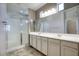 Bathroom features a dual sink vanity with ample counter space, large mirror and glass shower at 4242 E Erie St, Gilbert, AZ 85295