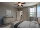 Bright bedroom with soft lighting, neutral walls, and a walk in closet. Features a sleek dresser at 4242 E Erie St, Gilbert, AZ 85295