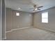 Neutral-colored bedroom with a ceiling fan, plush carpeting, and a window for natural light at 4242 E Erie St, Gilbert, AZ 85295