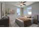 Neutral toned bedroom with comfortable bed, modern art, and large windows offering abundant natural light at 4242 E Erie St, Gilbert, AZ 85295