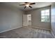 Bedroom with neutral walls and carpet, a ceiling fan, and an open door to a closet at 4242 E Erie St, Gilbert, AZ 85295