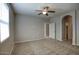 Spacious, carpeted bedroom features a ceiling fan and access to an open closet space at 4242 E Erie St, Gilbert, AZ 85295