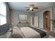Bright primary bedroom features a ceiling fan, neutral walls, and a plush bed for comfortable relaxation at 4242 E Erie St, Gilbert, AZ 85295