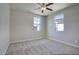 Well-lit bedroom with carpet, two windows, a ceiling fan and neutral walls at 4242 E Erie St, Gilbert, AZ 85295