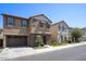 Street view showcasing a modern two-story home with stone details, a garage, and tidy landscaping at 4242 E Erie St, Gilbert, AZ 85295