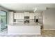 Bright and open kitchen with white cabinets, stainless steel appliances, granite counters, and island at 4242 E Erie St, Gilbert, AZ 85295