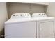 Laundry area with a white, front-loading washing machine and dryer at 4242 E Erie St, Gilbert, AZ 85295