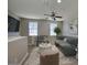 Bright, neutral living space featuring a ceiling fan, large windows, modern seating and a decorative rug at 4242 E Erie St, Gilbert, AZ 85295