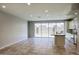 Open-concept living area featuring tile flooring, recessed lighting, and access to the backyard at 4242 E Erie St, Gilbert, AZ 85295