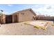 Rear view of property with minimal desert landscaping and fenced yard at 42758 W Camino De Janos --, Maricopa, AZ 85138