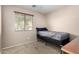 Neutral-toned bedroom with a twin bed and a window providing natural light at 42758 W Camino De Janos --, Maricopa, AZ 85138