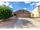 Single story home featuring desert landscaping, large garage, and neutral stucco exterior under blue skies at 42758 W Camino De Janos --, Maricopa, AZ 85138