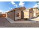 Single-story home's side view, featuring desert landscaping, stucco exterior, and dark framed windows at 42758 W Camino De Janos --, Maricopa, AZ 85138