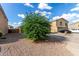 Two-story house with desert landscaping, two car garage and driveway under a beautiful cloudy blue sky at 42758 W Camino De Janos --, Maricopa, AZ 85138