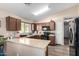 Functional kitchen with granite countertops, dark wood cabinets, and stainless steel appliances at 42758 W Camino De Janos --, Maricopa, AZ 85138