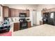 Functional kitchen with granite countertops, dark wood cabinets, and stainless steel appliances at 42758 W Camino De Janos --, Maricopa, AZ 85138