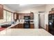 Functional kitchen with granite countertops, dark wood cabinets, and stainless steel appliances at 42758 W Camino De Janos --, Maricopa, AZ 85138