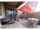 Cozy patio area with barbeque, seating, and shade covering, perfect for outdoor enjoyment at 42758 W Camino De Janos --, Maricopa, AZ 85138