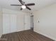 This bedroom features a ceiling fan, wood floors, and a closet with bi-fold doors at 4325 W Sierra St, Glendale, AZ 85304