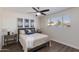 Comfortable bedroom with stylish decor, wood-look flooring, a ceiling fan, and a well-lit ambiance at 4325 W Sierra St, Glendale, AZ 85304