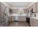 Bright kitchen featuring stainless steel appliances, white countertops, and plenty of cabinet space for storage at 4325 W Sierra St, Glendale, AZ 85304