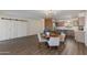 Open-concept living and dining area with modern lighting, neutral decor, and stylish wood-look flooring throughout at 4325 W Sierra St, Glendale, AZ 85304
