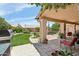 Relaxing backyard with a covered patio, lush lawn, barbecue, and well-maintained landscaping at 4401 E Barwick Dr, Cave Creek, AZ 85331