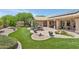 Beautiful backyard with artificial turf, brick patio, and desert landscaping perfect for outdoor dining at 4401 E Barwick Dr, Cave Creek, AZ 85331