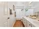 Bright bathroom with a double sink vanity, wooden floors and shower with white tiled walls at 4401 E Barwick Dr, Cave Creek, AZ 85331