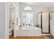 Bathroom with a soaking tub, a glass block window, and a walk-in shower at 4401 E Barwick Dr, Cave Creek, AZ 85331