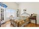 Cozy bedroom featuring a charming patchwork quilt, hardwood floors, and ample natural light at 4401 E Barwick Dr, Cave Creek, AZ 85331