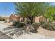 Attractive single-story home with mature landscaping, desert plants, and a three-car garage at 4401 E Barwick Dr, Cave Creek, AZ 85331